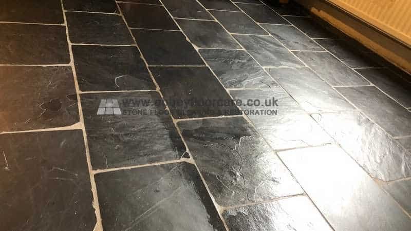 Sealer being applied to restored slate floor after stripping and drying checks