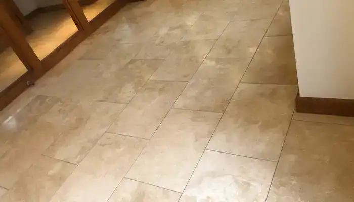 Travertine floor restored to an even natural finish showcasing consistent surface tone